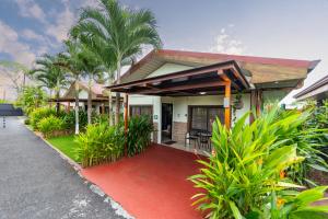 a house with a red carpet in front of it at Hormiga's Houses La Fortuna in Fortuna