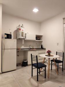 a kitchen with a table and chairs and a refrigerator at Casa Arpy in Mendoza