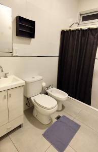 a bathroom with a toilet and a sink at Casa Arpy in Mendoza