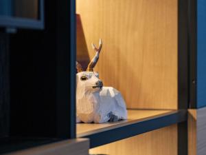 a statue of a deer head sitting on a shelf at Novotel Nara in Nara
