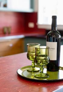 a plate with two glasses and a bottle of wine at Alaskan Hideaway | Cozy & Adventure-Ready in Anchorage