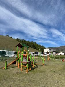 a playground with a slide in a field at Bayalag Resort in Yoliin Hural
