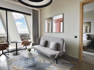 a living room with a couch and a table at Novotel Abidjan Marcory in Abidjan