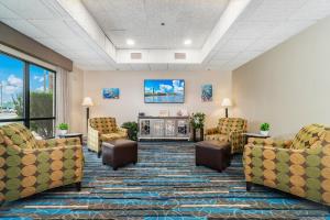 a waiting room with couches and a fireplace at The Windstar Hotel - Emerald Isle, Swansboro in Cedar Point