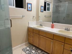 a bathroom with two sinks and a large mirror at WM Private master suite with separate entry in San Jose