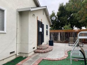 a building with a gate and a bench in a yard at WM Private master suite with separate entry in San Jose