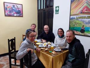 a group of people sitting around a table at Qoricancha B&B Cusco in Cusco