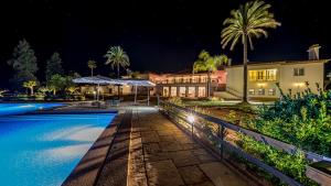 a house with a swimming pool at night at Herdade das Bernardas B&B in Vila Verde de Ficalho