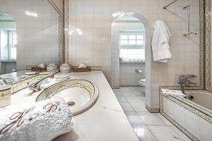 a bathroom with a tub and a toilet and a sink at Herdade das Bernardas B&B in Vila Verde de Ficalho +7 photos