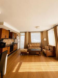 a living room with a couch and a table at Transylvania Villa & Spa in Gosau