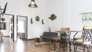 a living room with chairs and a table and a couch at Zapotitlán Lofts in Retalhuleu