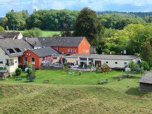 an aerial view of a farm with red buildings at Paganetti´s Chalet in Breitscheid