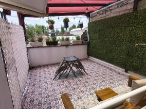 a small balcony with a table and bench on a tile floor at Loft Santa Rosa in Apizaco