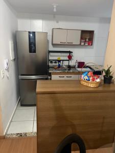 a kitchen with a stainless steel refrigerator and a counter at Apto 2 qts em Xerém próximo ao CT do Fluminense in Duque de Caxias