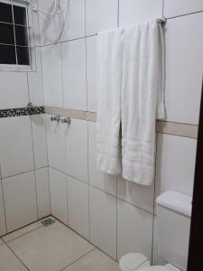 a bathroom with a shower with white towels at Chalé Luar da Serra in Camanducaia +26 photos