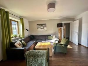 a living room with a couch and a table at Chalet with Mountain View in Piesendorf