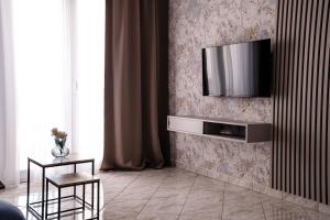 a living room with a television on a wall at Villa Grubešić - Sea View Apartments in Kustići