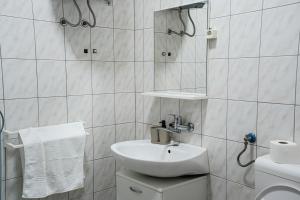 a white bathroom with a sink and a shower at Villa Grubešić - Sea View Apartments in Kustići +26 photos