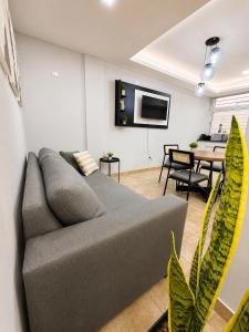 a living room with a gray couch and a table at Paramont Rosario 2 in Rosario de la Frontera