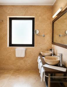 a bathroom with two sinks and a large mirror at Transylvania Villa & Spa in Gosau +41 photos