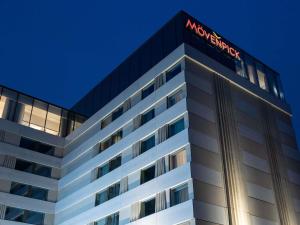 a building with a macys sign on top of it at Mövenpick Hotel Brussels Airport in Zaventem