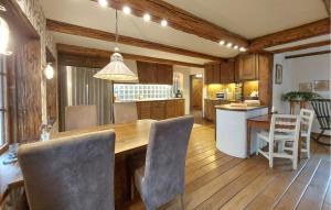 a kitchen and dining room with a table and chairs at Villa Kalle in Åstorp