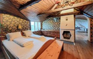 a large bed in a room with a fireplace at Villa Kalle in Åstorp