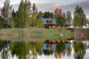 a house on the shore of a lake at Paegli Guest house in Kaijciems