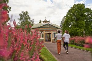 a man and a woman walking in front of a building at Sovereign Park Motor Inn in Ballarat