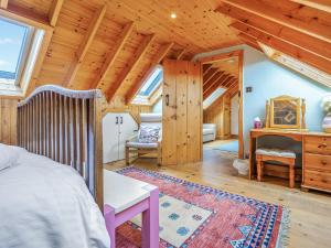 a bedroom with a bed and a wooden ceiling at Seaton Cottage - Uk31990 in Staithes +35 photos