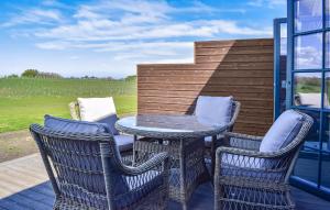 a patio with a table and chairs on a deck at Beautiful Home In Kivik in Kivik +14 photos