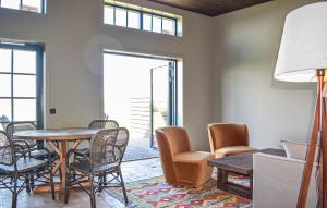 a dining room with a table and chairs at Beautiful Home In Kivik in Kivik
