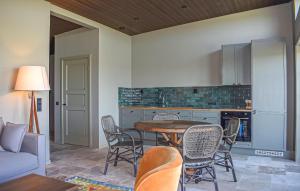 a kitchen with a table and chairs in a room at Beautiful Home In Kivik in Kivik
