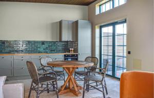 a kitchen with a wooden table and chairs at Beautiful Home In Kivik in Kivik