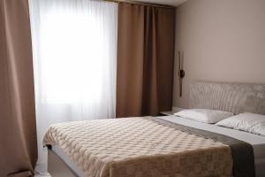 a bedroom with a bed with a large window at Villa Grubešić - Sea View Apartments in Kustići