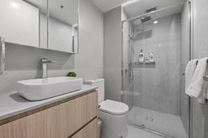 a bathroom with a shower and a sink and a toilet at Central 2b2b with 2 Parkings across largest Mall in Braddon +17 photos