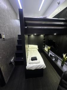 a room with a bunk bed and a staircase at Cloud & Rey condo rentals in Roxas City +12 photos
