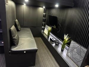 a living room with a couch and a flat screen tv at Cloud & Rey condo rentals in Roxas City