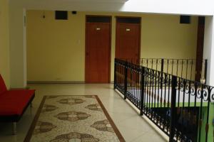 a hallway with two doors and a rug at Balneario del Inca in Los Baños del Inca