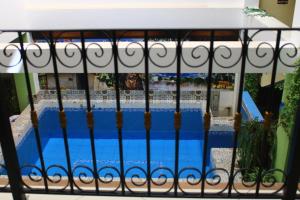 a view of a swimming pool through a fence at Balneario del Inca in Los Baños del Inca