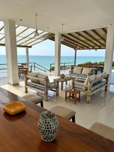 a living room with a table and a view of the ocean at Hotel Punta Blanca - Jama - Manabí in Jama