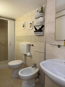 a bathroom with a toilet and a sink at More Apartments il castello in Bari +2 photos