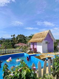 a pool at a resort with people in it at Kurau Stone Chalet in Taiping