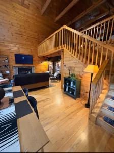 a living room with a staircase in a cabin at Cozymountainretreat in Jasper