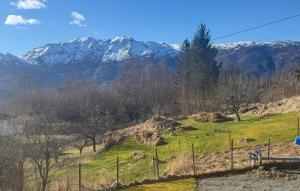 a hill with snow covered mountains in the background at 5 Bedroom Amazing Home In Matre in Bauge