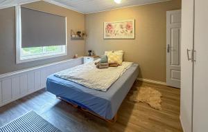 a bedroom with a bed and a window at 5 Bedroom Amazing Home In Matre in Bauge