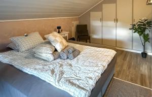 a bedroom with a bed with three pillows on it at 5 Bedroom Amazing Home In Matre in Bauge +7 photos