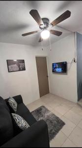 a living room with a ceiling fan and a couch at Departamento MAR in Coatzacoalcos