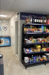 a store aisle with shelves of food and drinks at Apartamento 02 QUARTOS, confortável no coração da Pampulha in Belo Horizonte