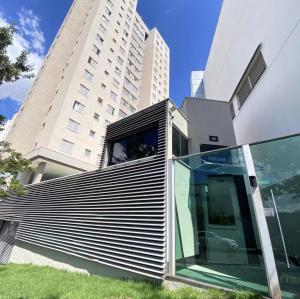 a building with a glass door in front of a building at Apartamento 02 QUARTOS, confortável no coração da Pampulha in Belo Horizonte